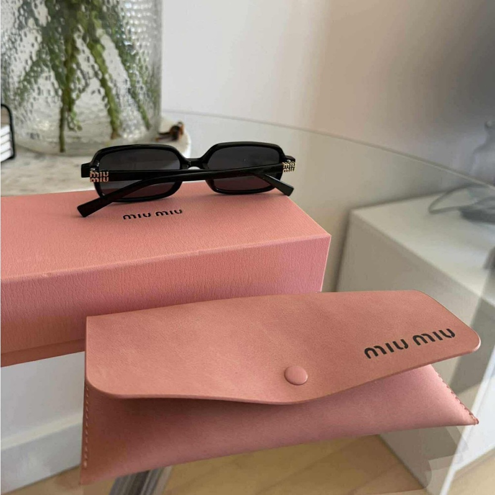 Miu Miu Black Modern Sunglasses with Sleek Design